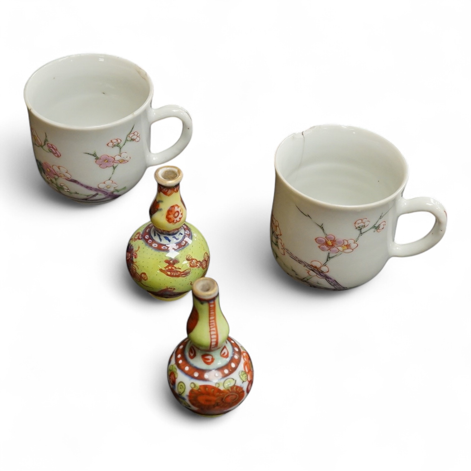 Two Chinese famille rose cups, Yongzheng period and two miniature clobbered vases, largest 6cm high